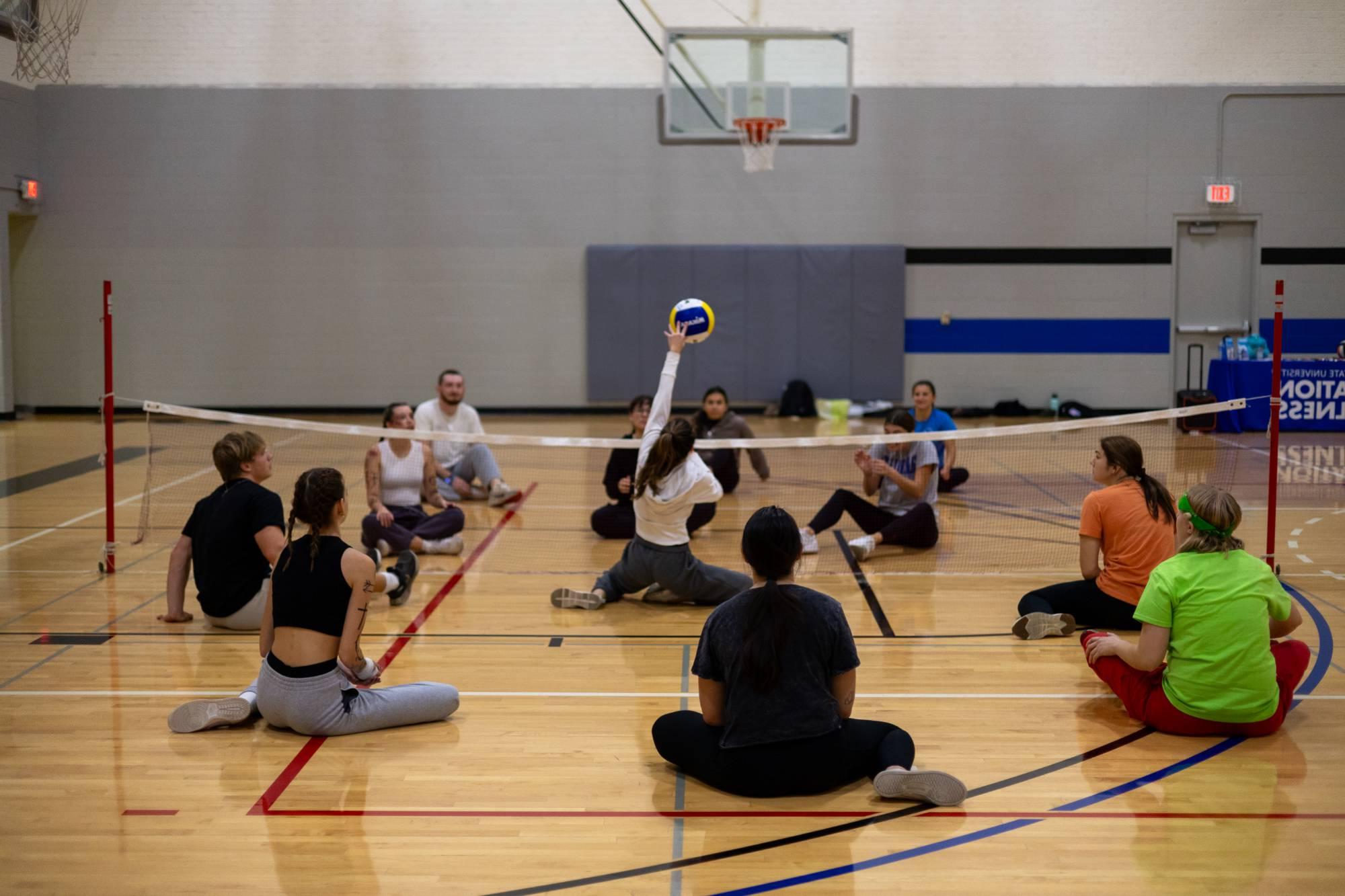 Students playing seated volleyball at an adaptive intramural sports event